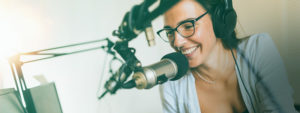a young man at a microphone. A radio broadcast in production